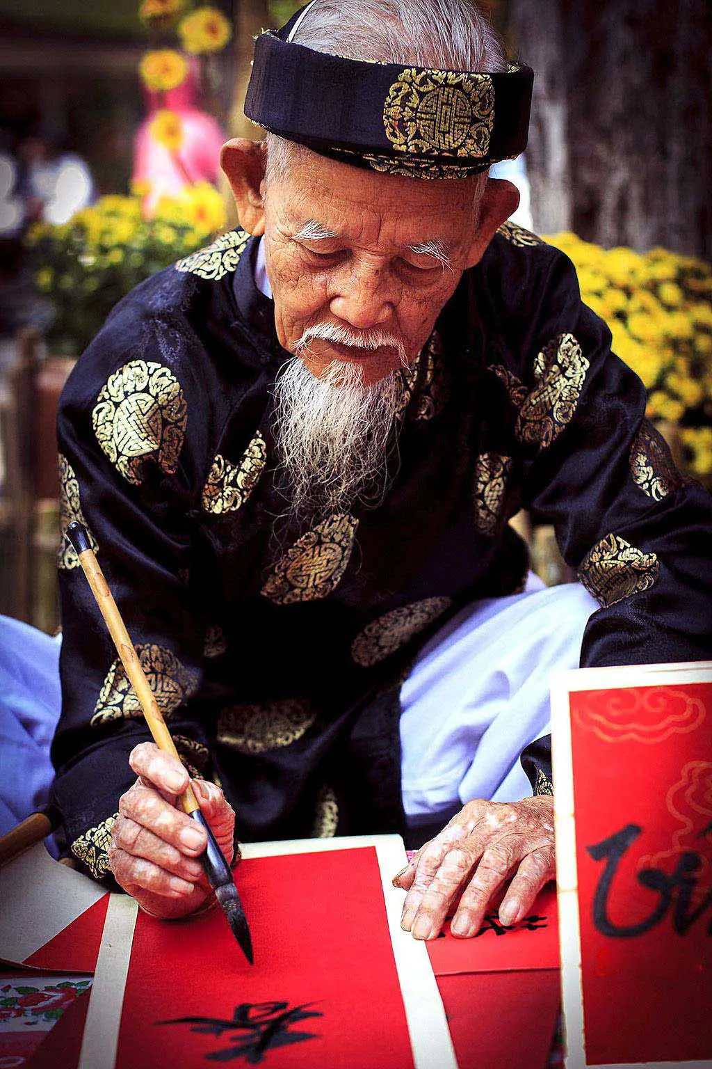 Calligrapher using brush on paper in Hanoi