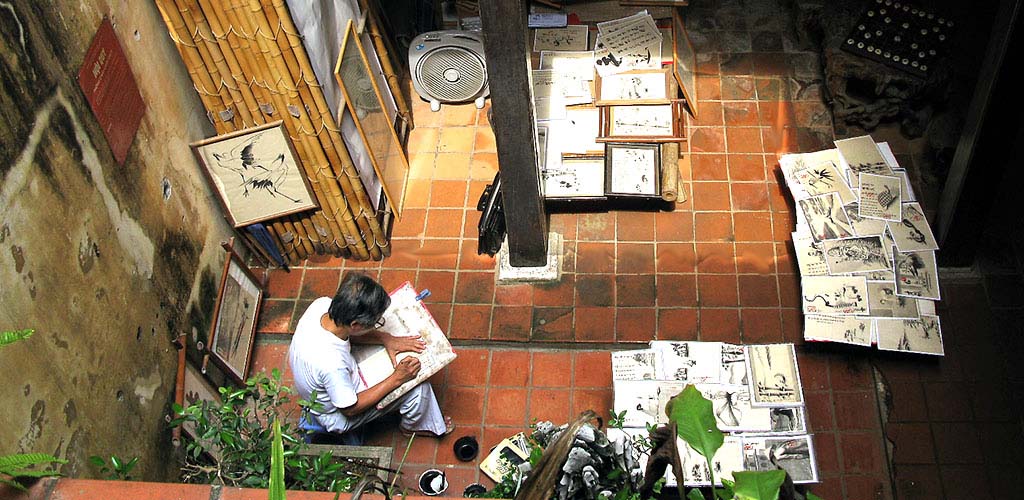 Vietnamese artist sketching in home studio