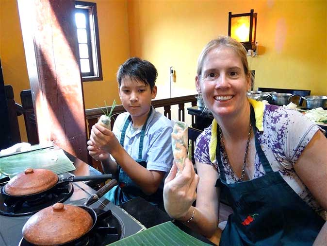 Making spring rolls in a cooking class in Hoi An
