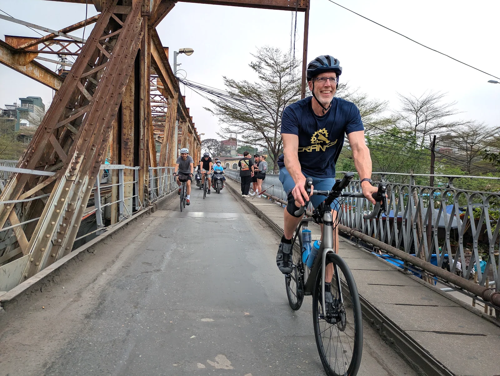 Cycling the historic Cầu Long Biên bridge across the Red River in Hanoi