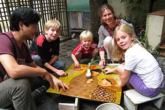 Family tour of Vietnam creating lacquerware
